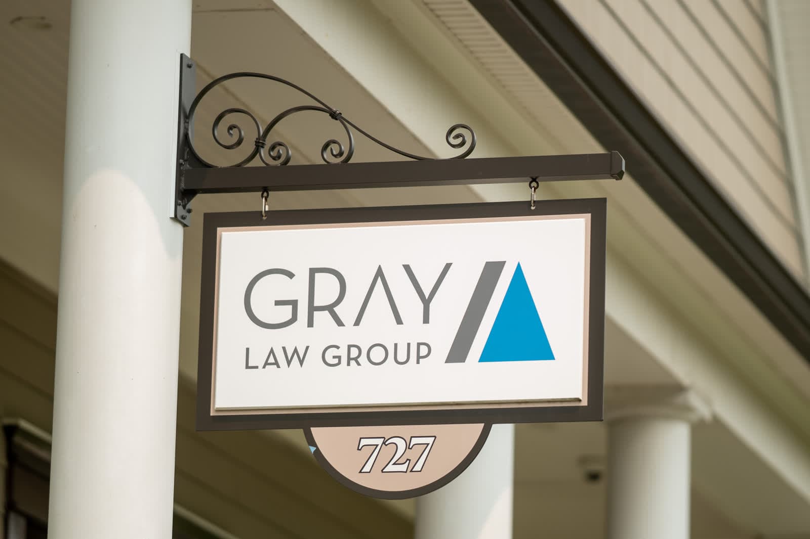 The hanging Gray Law Group sign marking suite 727
